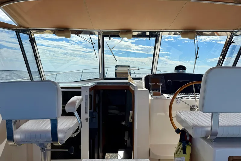St. Elmo's Fire II Yacht Photos Pics Interior view of a 1999 Legacy 40 boat cockpit with ocean backdrop.
