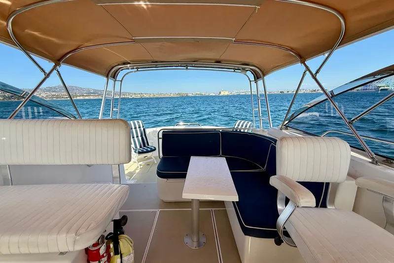 St. Elmo's Fire II Yacht Photos Pics Interior view of a 1999 Legacy 40 boat with seating and ocean backdrop.