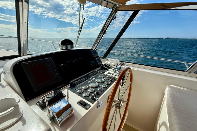 St. Elmo's Fire II Yacht Photos Pics Helm of 1999 Legacy 40 yacht with ocean view and clear sky.