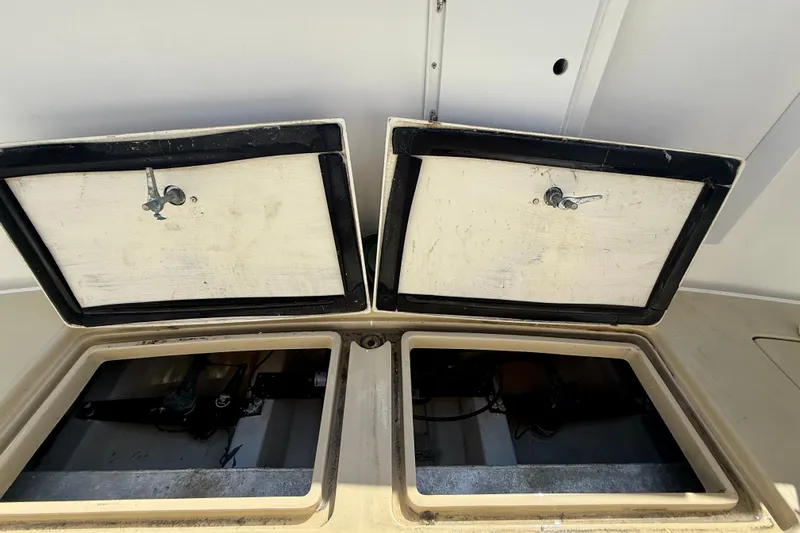 St. Elmo's Fire II Yacht Photos Pics Open storage compartments on a 1999 Legacy 40 boat, showcasing interior details.