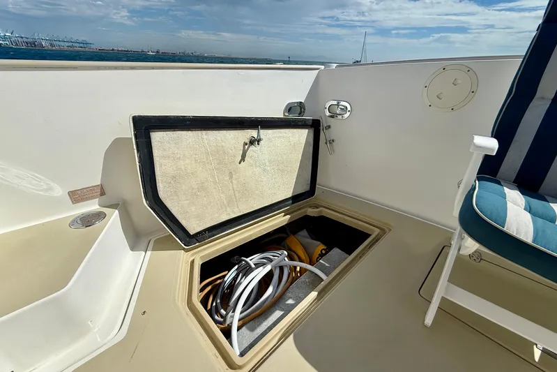 St. Elmo's Fire II Yacht Photos Pics Open storage compartment on 1999 Legacy 40 boat deck with coiled cables inside.
