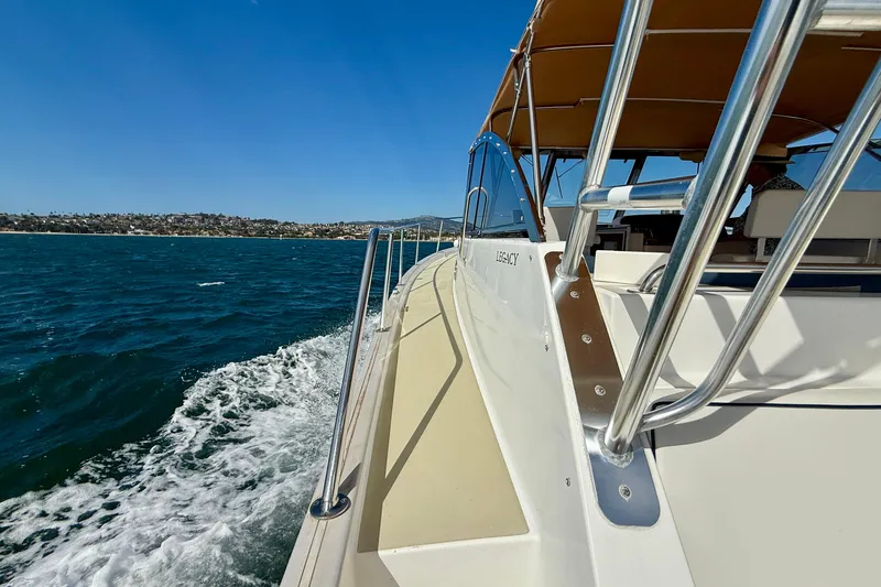 St. Elmo's Fire II Yacht Photos Pics 1999 Legacy 40 boat cruising on open water under clear blue sky.