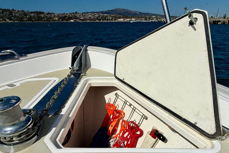 St. Elmo's Fire II Yacht Photos Pics Open storage compartment on 1999 Legacy 40 boat with life jackets, ocean view.