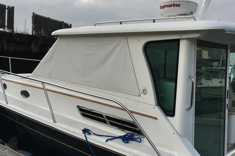 Tranquility Yacht Photos Pics 2008 Back Cove 33 Hard Top Express boat docked, featuring sleek design and Raymarine equipment.