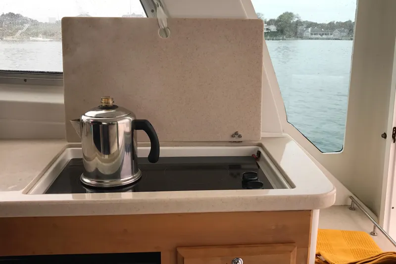 Tranquility Yacht Photos Pics 2008 Back Cove 33 Hard Top Express galley with kettle on stove, overlooking water.