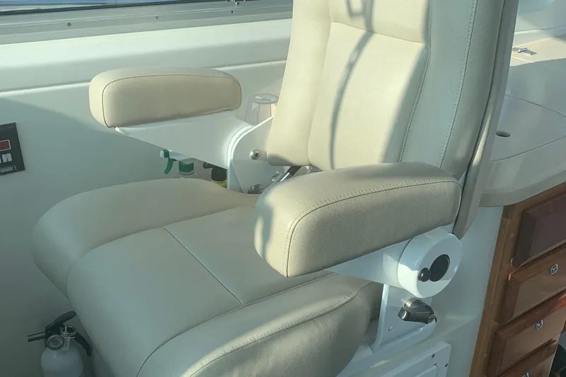 Tranquility Yacht Photos Pics Captain's chair on 2008 Back Cove 33 Hard Top Express boat, featuring beige upholstery.