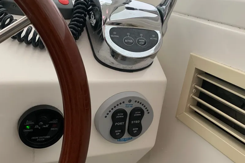 Tranquility Yacht Photos Pics 2008 Back Cove 33 Hard Top Express helm controls with steering wheel and trim tab panel.