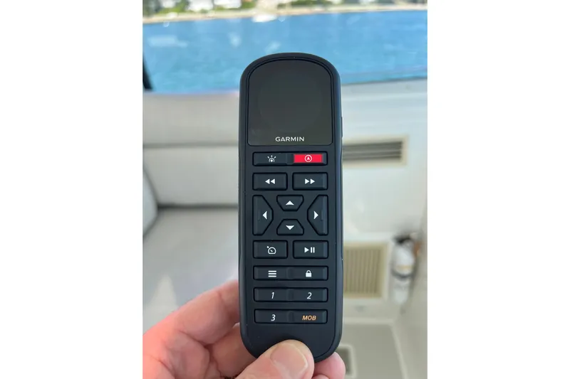 Tranquility Yacht Photos Pics Hand holding Garmin remote control on a 2008 Back Cove 33 Hard Top Express boat.