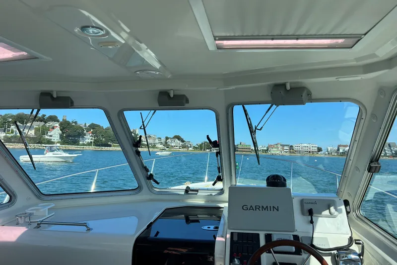 Tranquility Yacht Photos Pics Interior view from a 2008 Back Cove 33 Hard Top Express, overlooking a coastal town.