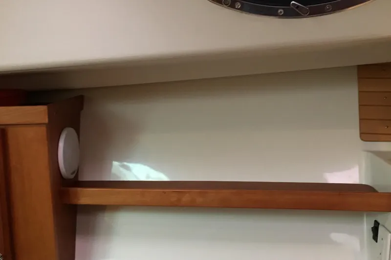 Tranquility Yacht Photos Pics Interior of 2008 Back Cove 33 Hard Top Express, featuring wooden shelf and porthole.