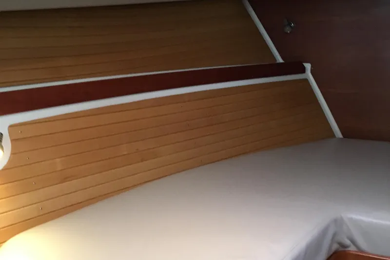 Tranquility Yacht Photos Pics 2008 Back Cove 33 Hard Top Express cabin interior with wood paneling and bed.