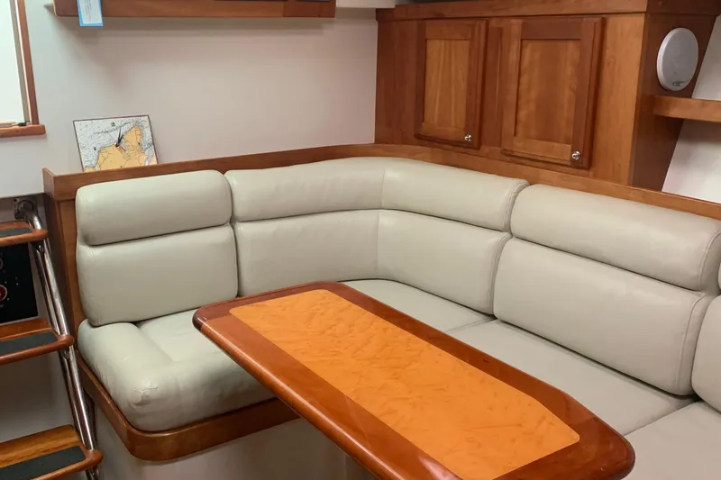 Tranquility Yacht Photos Pics 2008 Back Cove 33 Hard Top Express interior with beige seating and wooden cabinetry.