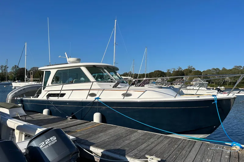 Tranquility Yacht Photos Pics 2008 Back Cove 33 Hard Top Express docked at marina under clear blue sky.