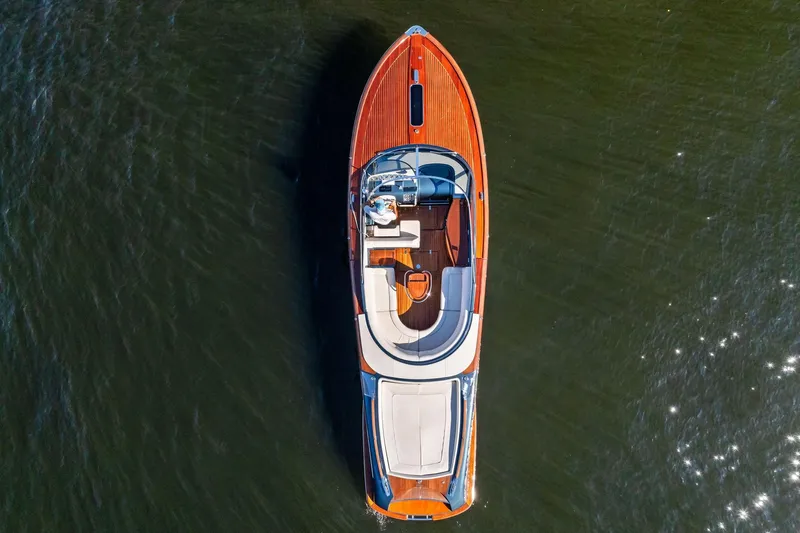 Isola Yacht Photos Pics Overhead view of 2013 Riva 33 Aquariva luxury boat on water.