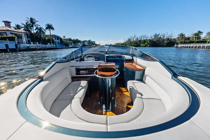 Isola Yacht Photos Pics Luxurious 2013 Riva 33 Aquariva boat interior on a sunny waterway.