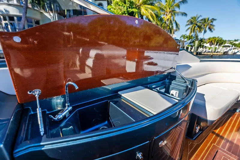 Isola Yacht Photos Pics Luxurious 2013 Riva 33 Aquariva yacht interior with sleek kitchenette and elegant wood finish.