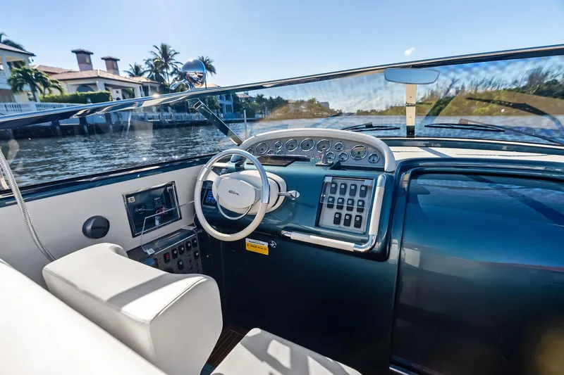 Isola Yacht Photos Pics Interior view of a 2013 Riva 33 Aquariva yacht, showcasing the sleek dashboard and steering wheel.