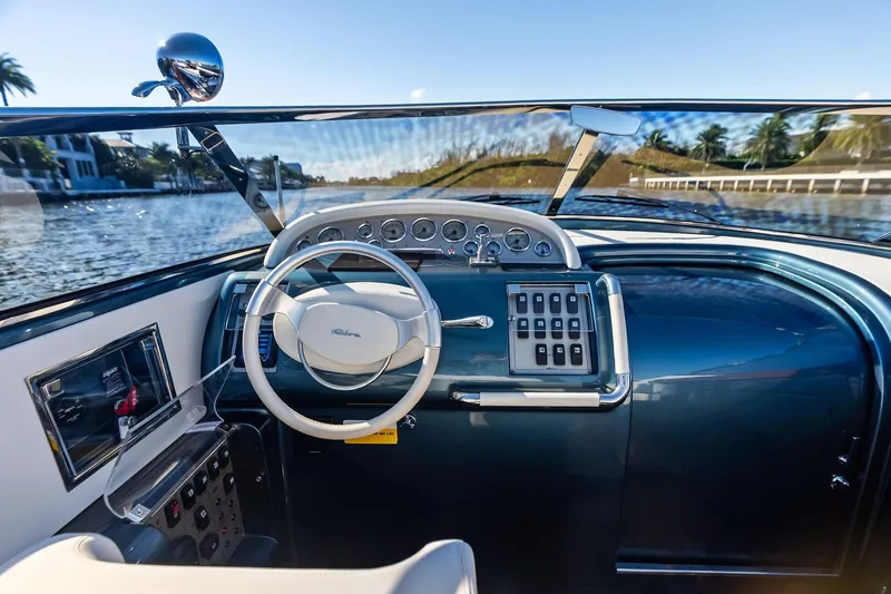 Isola Yacht Photos Pics Interior view of 2013 Riva 33 Aquariva boat cockpit with steering wheel and controls.