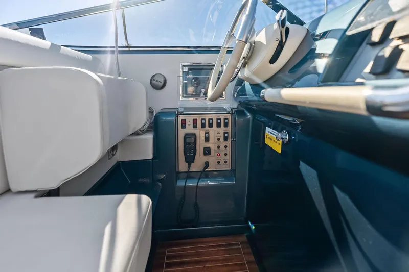 Isola Yacht Photos Pics Interior of 2013 Riva 33 Aquariva boat, featuring steering wheel and control panel.