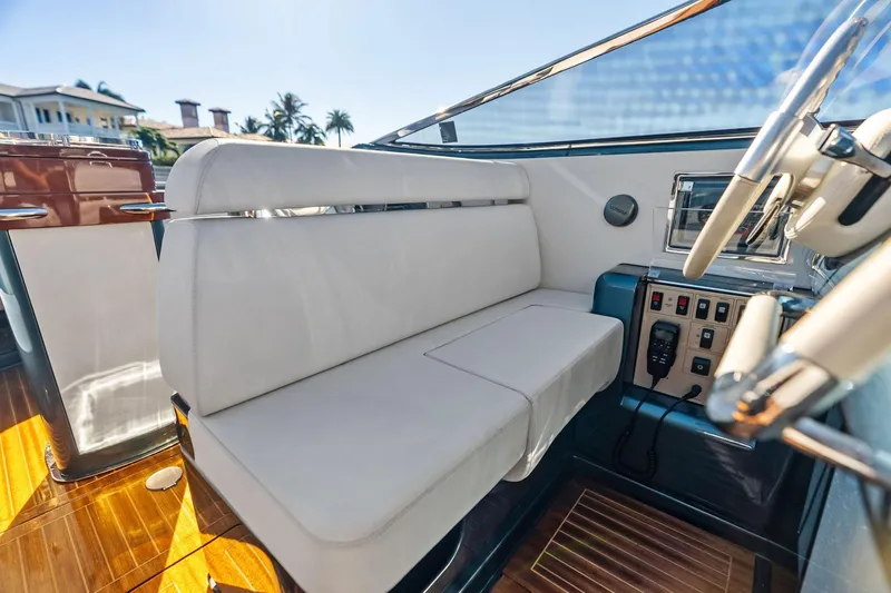 Isola Yacht Photos Pics Interior of 2013 Riva 33 Aquariva boat with white seating and control panel.