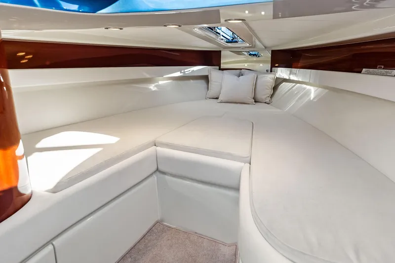Isola Yacht Photos Pics Luxurious interior cabin of 2013 Riva 33 Aquariva with plush white seating.