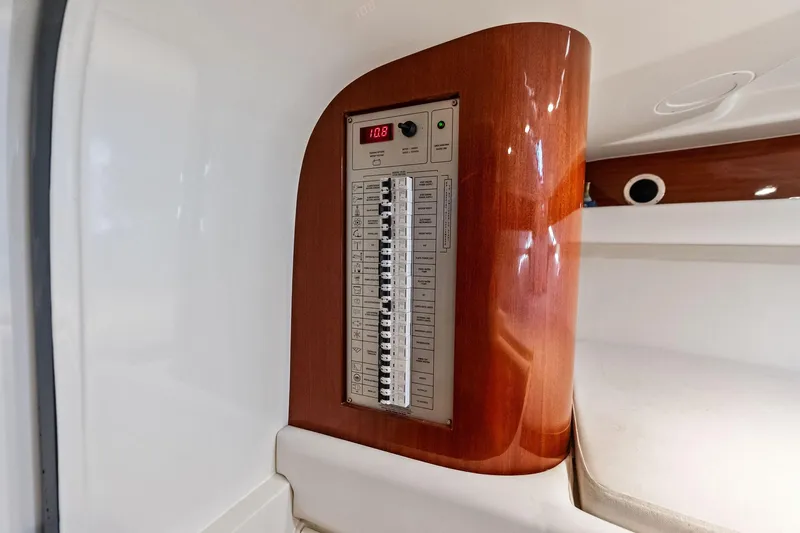 Isola Yacht Photos Pics Electrical panel inside 2013 Riva 33 Aquariva boat, featuring wood finish and modern controls.