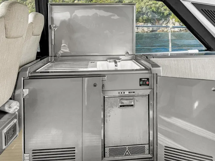  Yacht Photos Pics Modern kitchenette on 2022 Azimut Atlantis 51 yacht with sleek design and ocean view.