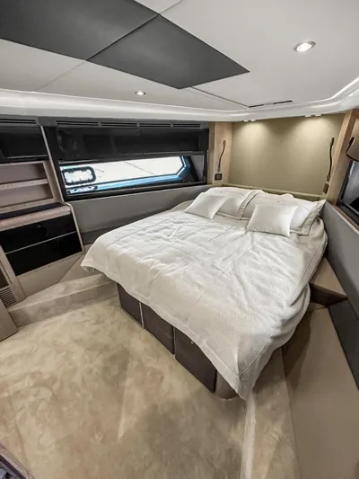  Yacht Photos Pics Luxurious bedroom interior of 2022 Azimut Atlantis 51 yacht with modern design and cozy bedding.