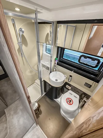  Yacht Photos Pics Luxurious bathroom in 2022 Azimut Atlantis 51 yacht with modern fixtures and shower.