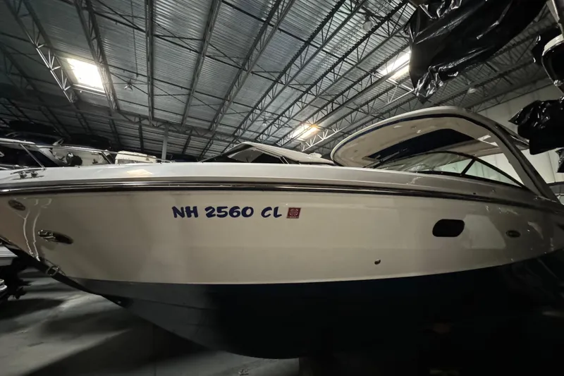  Yacht Photos Pics 2020 Sea Ray SLX 310 boat in indoor storage, side view.