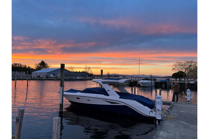  Yacht Photos Pics 2020 Sea Ray SLX 310 boat docked at sunset with vibrant sky.
