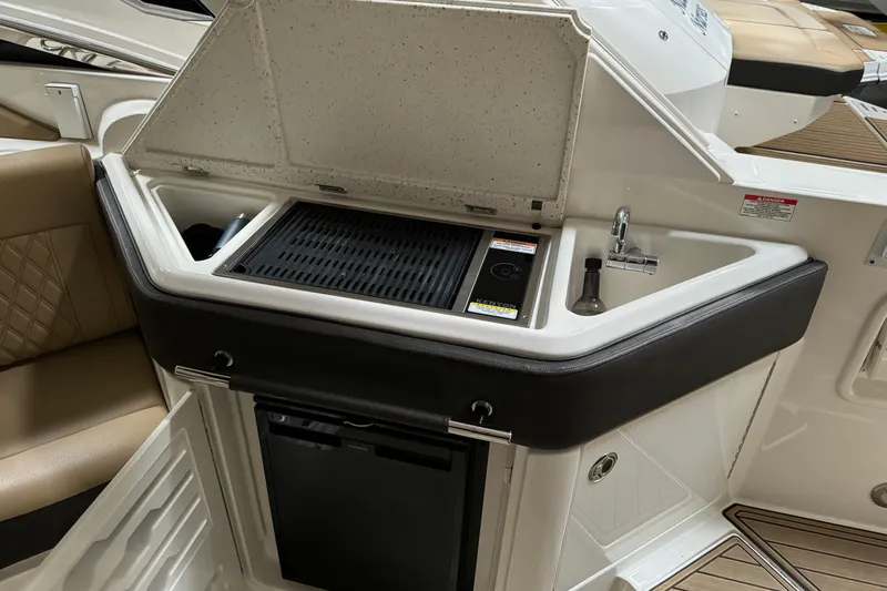  Yacht Photos Pics 2020 Sea Ray SLX 310 boat kitchenette with grill, sink, and mini fridge.