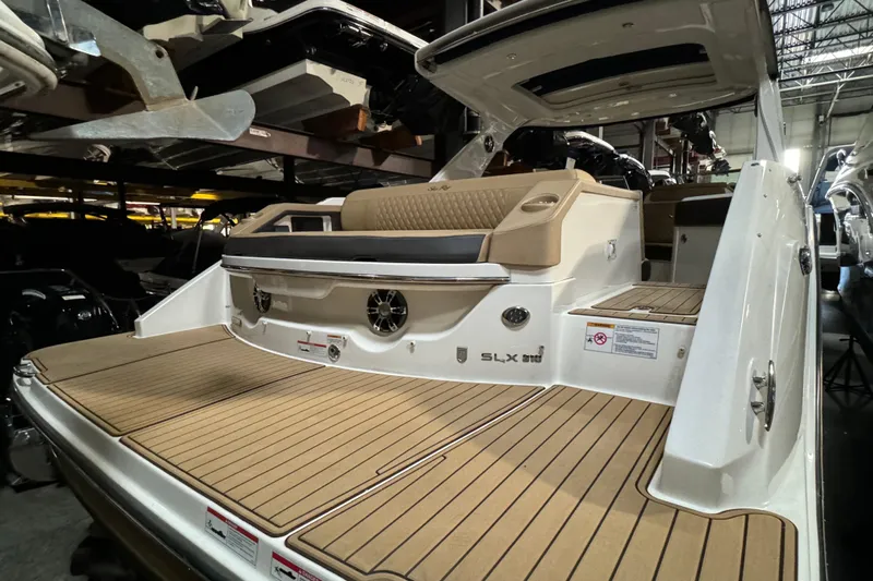  Yacht Photos Pics 2020 Sea Ray SLX 310 boat with spacious deck and luxurious seating in a showroom.