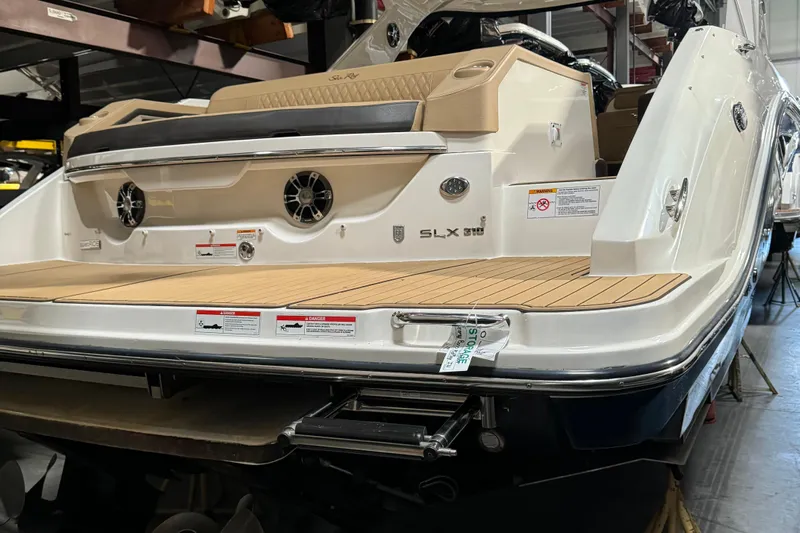  Yacht Photos Pics 2020 Sea Ray SLX 310 boat with teak swim platform in a storage facility.