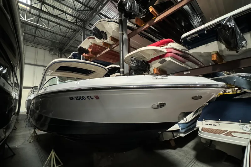  Yacht Photos Pics 2020 Sea Ray SLX 310 boat stored indoors, surrounded by other boats.