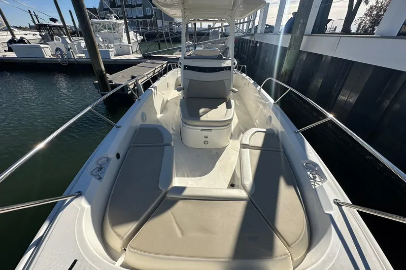 Bae Life Yacht Photos Pics 2022 Boston Whaler 270 Dauntless boat docked, featuring spacious seating and sleek design.