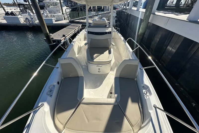 Bae Life Yacht Photos Pics 2022 Boston Whaler 270 Dauntless boat docked, showcasing spacious seating and sleek design.