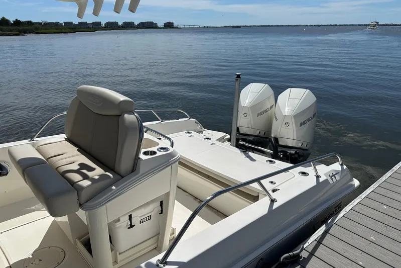 Bae Life Yacht Photos Pics 2022 Boston Whaler 270 Dauntless boat with twin Mercury engines docked by the water.