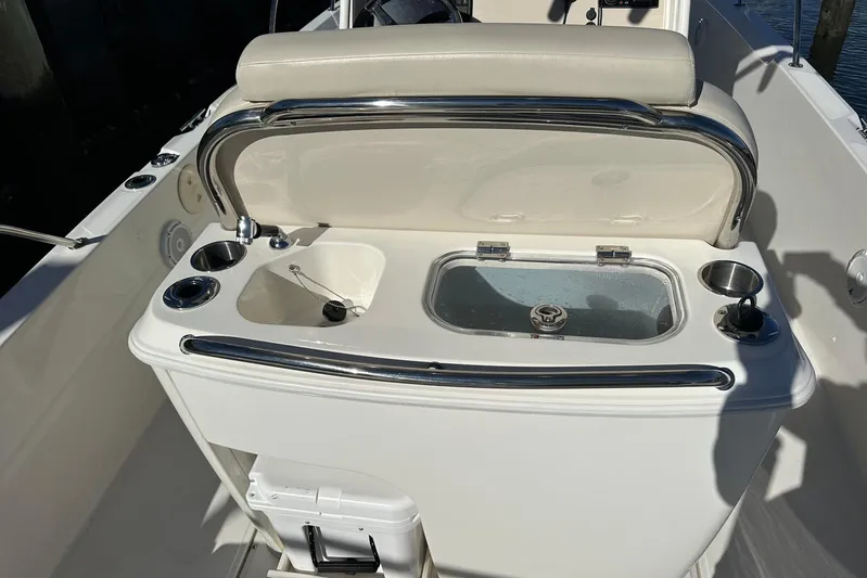 Bae Life Yacht Photos Pics 2022 Boston Whaler 270 Dauntless boat interior with sink and storage area.