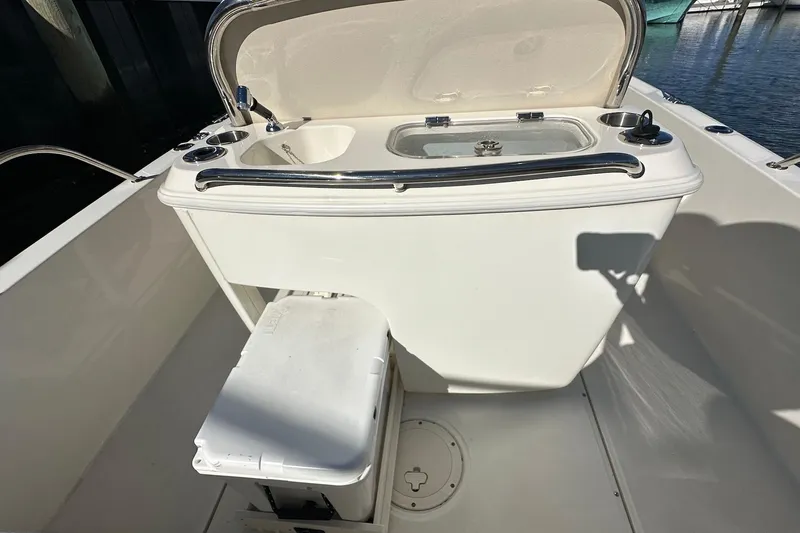 Bae Life Yacht Photos Pics 2022 Boston Whaler 270 Dauntless boat with open storage compartment and cooler.