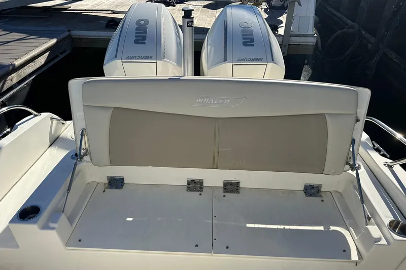 Bae Life Yacht Photos Pics 2022 Boston Whaler 270 Dauntless boat with dual Mercury outboard engines at dock.