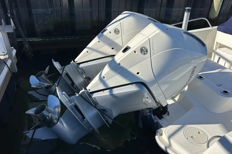Bae Life Yacht Photos Pics 2022 Boston Whaler 270 Dauntless with dual Mercury outboard engines, docked in water.