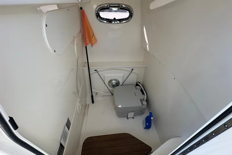 Bae Life Yacht Photos Pics Interior of 2022 Boston Whaler 270 Dauntless boat with compact marine toilet.