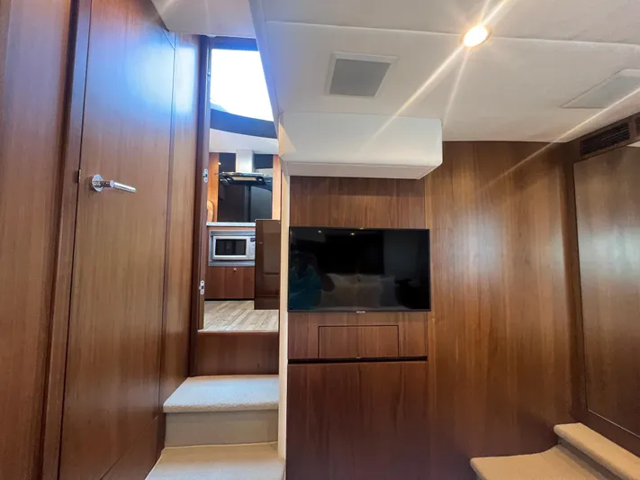  Yacht Photos Pics Luxurious interior of 2015 Viking Princess V52 yacht with wood paneling and modern amenities.