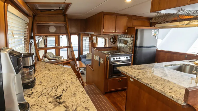  Yacht Photos Pics Luxurious 2002 Kristen Yachts Pilothouse Explorer 52 interior with modern kitchen and cozy seating area.