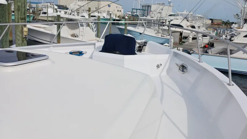  Yacht Photos Pics 2002 Kristen Yachts Pilothouse Explorer 52 docked at a marina, showcasing sleek deck design.