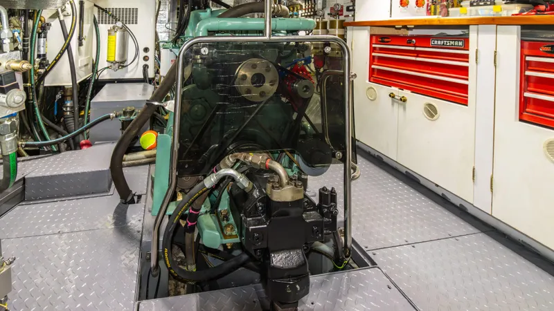  Yacht Photos Pics Engine room of 2002 Kristen Yachts Pilothouse Explorer 52 with visible machinery and tool storage.