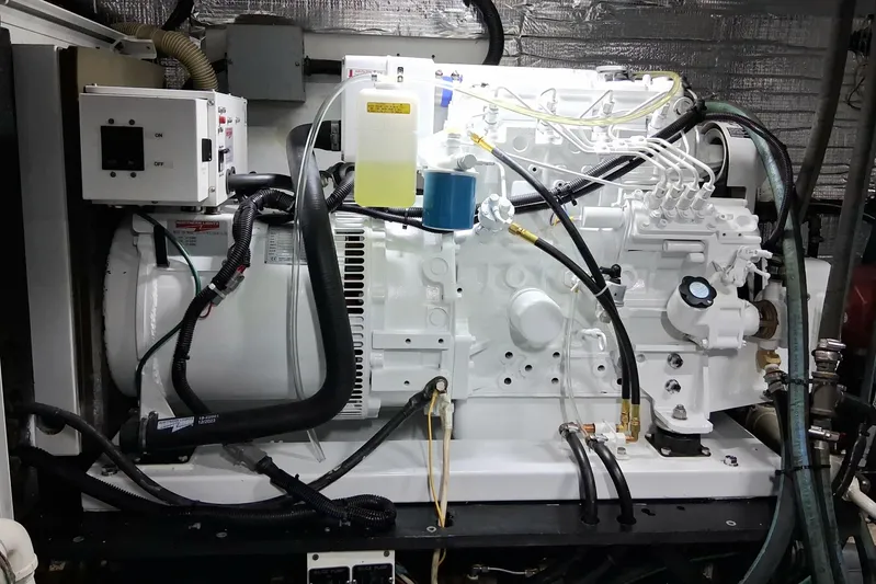  Yacht Photos Pics Engine room of 2002 Kristen Yachts Pilothouse Explorer 52, showcasing mechanical components.