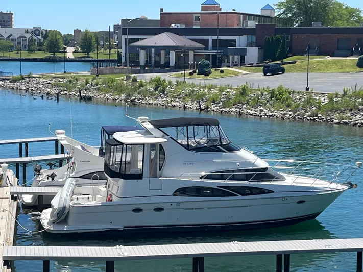  Yacht Photos Pics 2005 Carver 44 CMY yacht docked in a marina with scenic waterfront view.