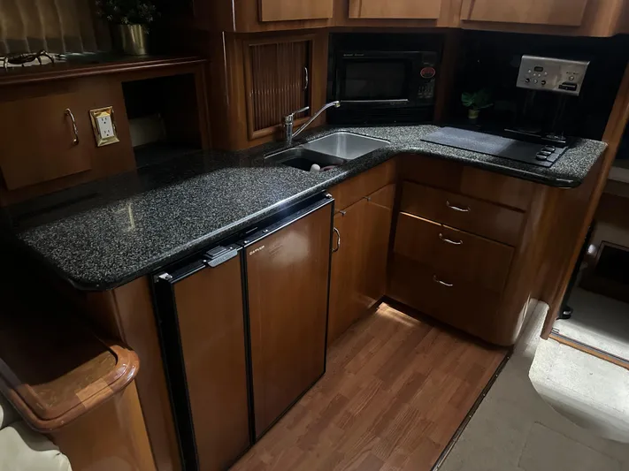  Yacht Photos Pics Luxurious kitchen in 2005 Carver 44 CMY yacht with granite countertops and modern appliances.
